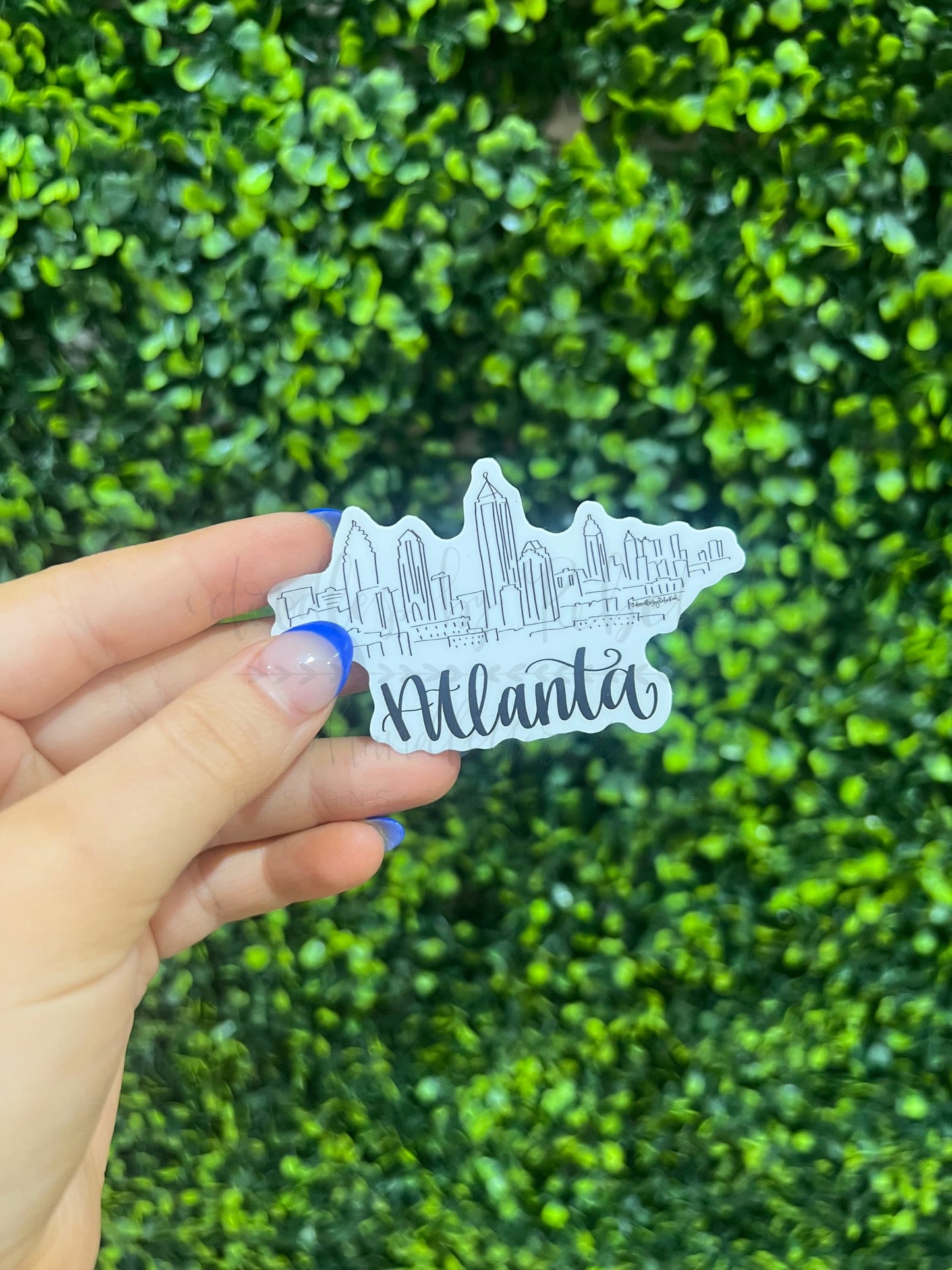 White sticker showing doodle of Atlanta skyline