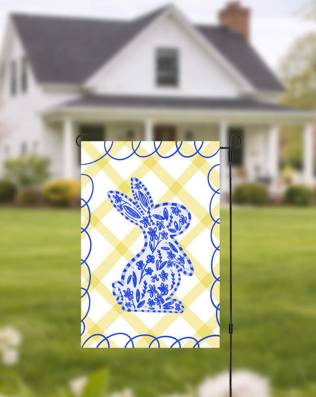 Doodles by Rebekah blue floral bunny garden flag featuring a whimsical hand-painted rabbit silhouette on a yellow checkered background. This charming spring and Easter outdoor decor is perfect for front yards, gardens, or seasonal porch displays.