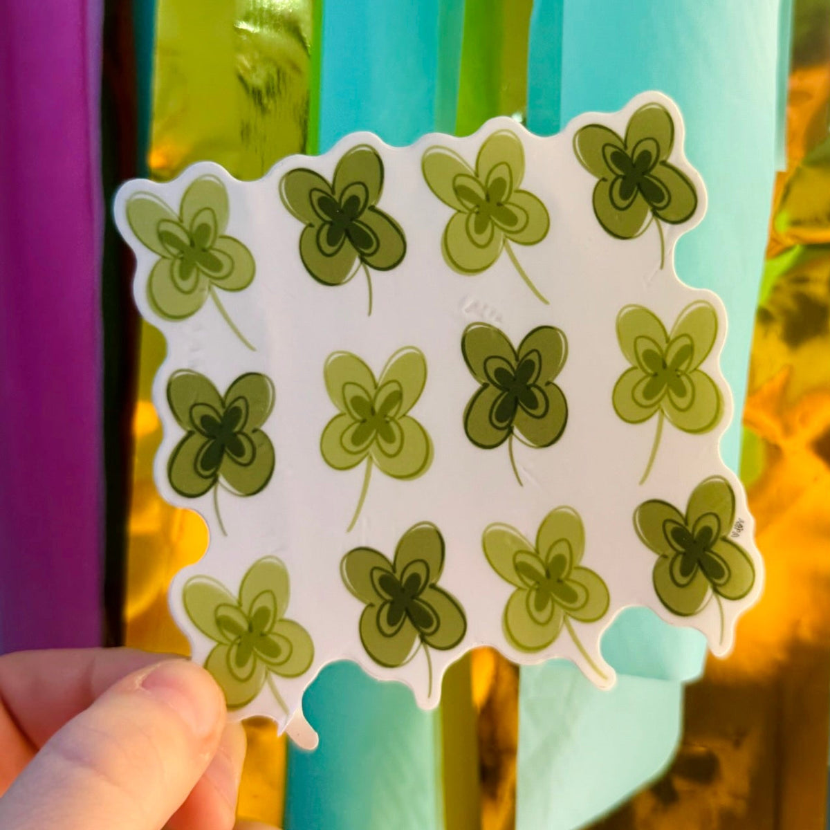 Doodles by Rebekah four-leaf clover pattern vinyl sticker. This whimsical hand-painted green botanical decal is a perfect St. Patrick's Day gift or lucky charm for decorating water bottles, laptops, and planners.