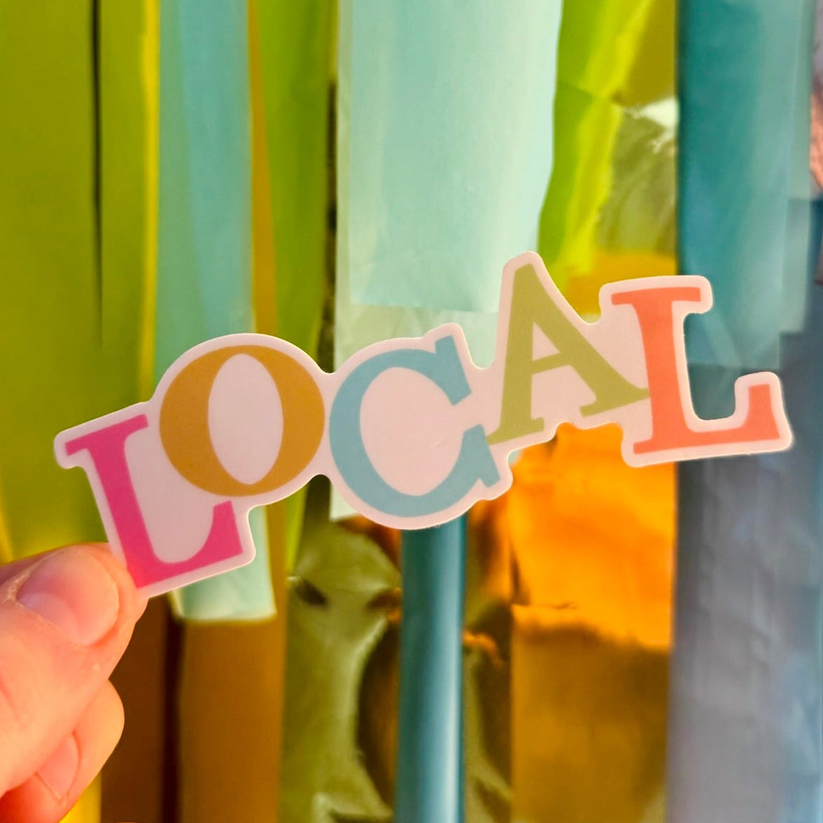Doodles by Rebekah "LOCAL" pastel typography vinyl sticker. This whimsical, multi-colored lettering decal is a perfect way to show community pride on water bottles, laptops, and car windows.