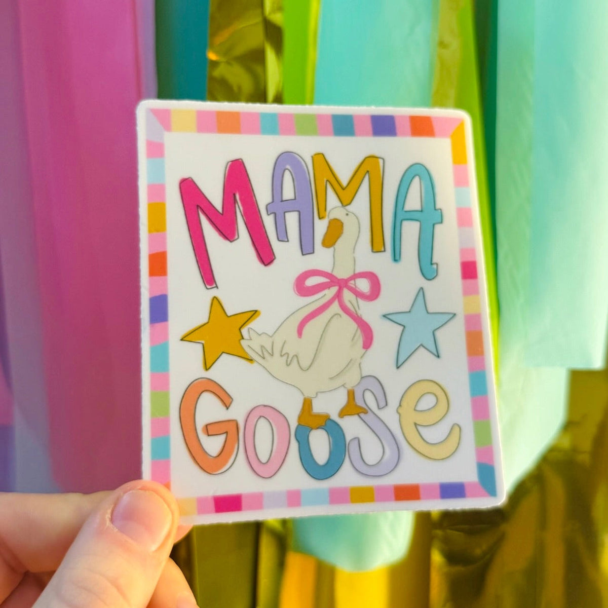 Doodles by Rebekah "MAMA Goose" whimsical rectangular sticker. This colorful hand-painted vinyl decal with a goose illustration and rainbow-striped border is a perfect gift for mothers to decorate water bottles, laptops, and nurseries.