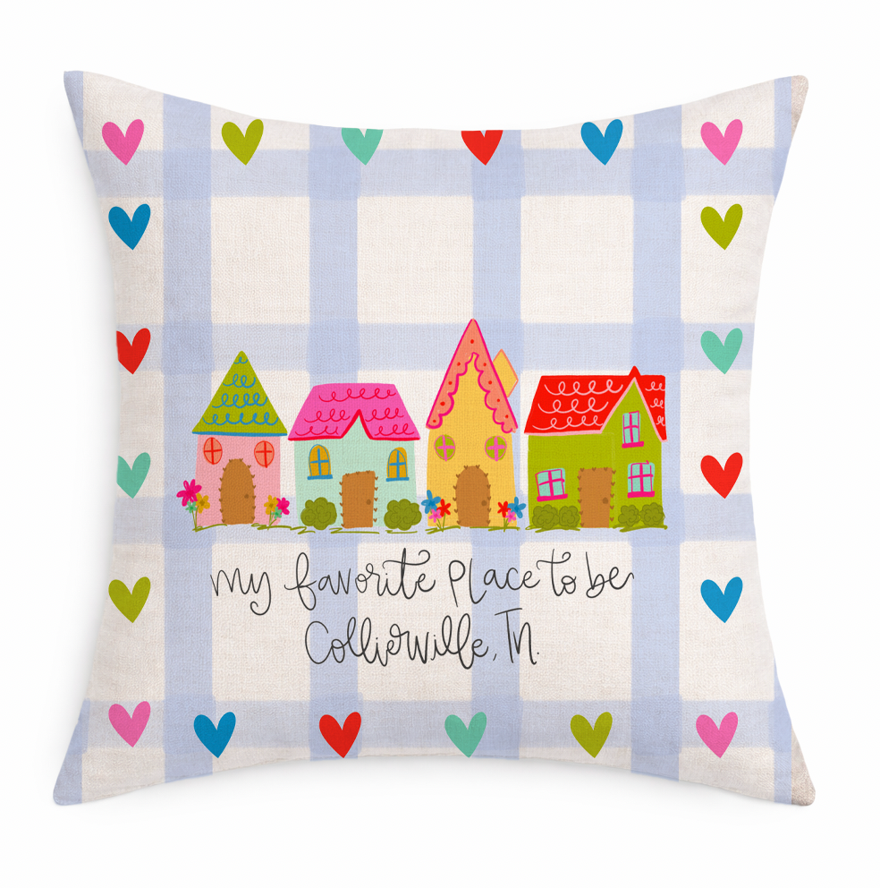 Decorative pillow with colorful houses and hearts on a plaid background