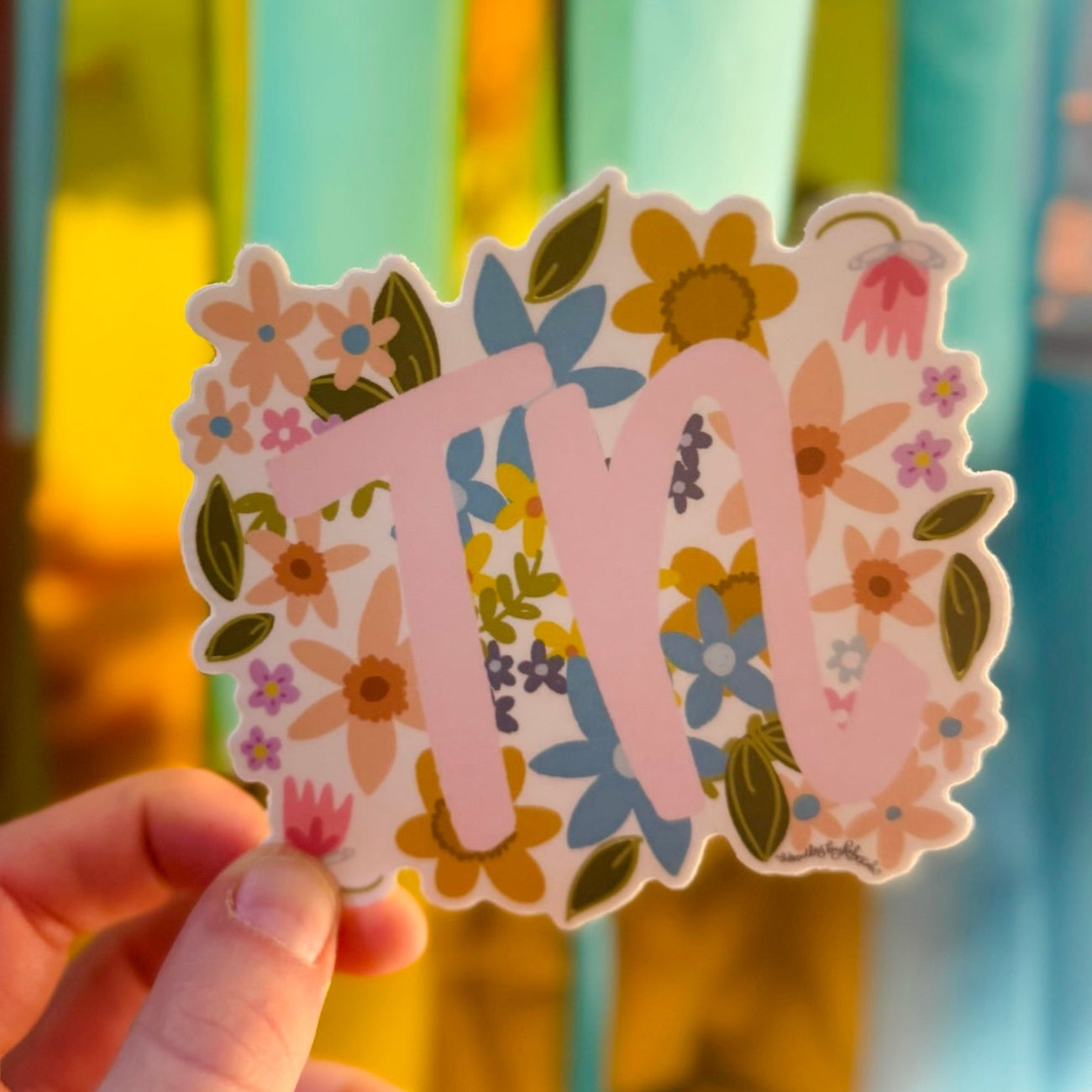 Doodles by Rebekah Tennessee "TN" state pride floral sticker. This whimsical hand-painted vinyl decal with botanical accents and pink lettering is a perfect gift for Tennesseans to decorate water bottles, laptops, and planners.