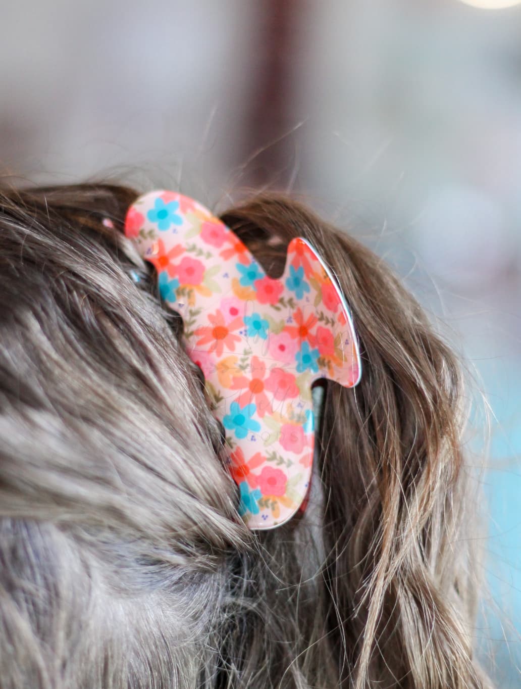Large floral hair claw clip in use, demonstrating a decorative and functional hair accessory for medium to thick hair.