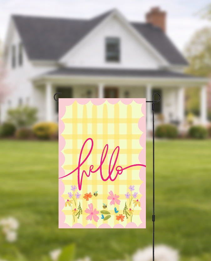 Doodles by Rebekah "Hello" floral garden flag featuring whimsical hand-painted typography and a yellow checkered pattern. This vibrant outdoor seasonal decor is perfect for welcoming guests to a front yard, garden, or porch.