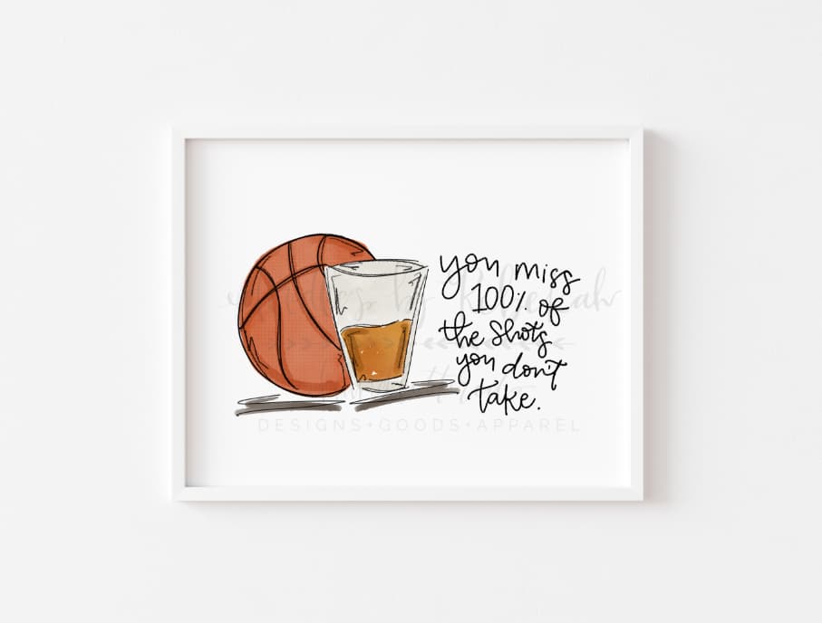 White framed print with image of basketball and a shot glass