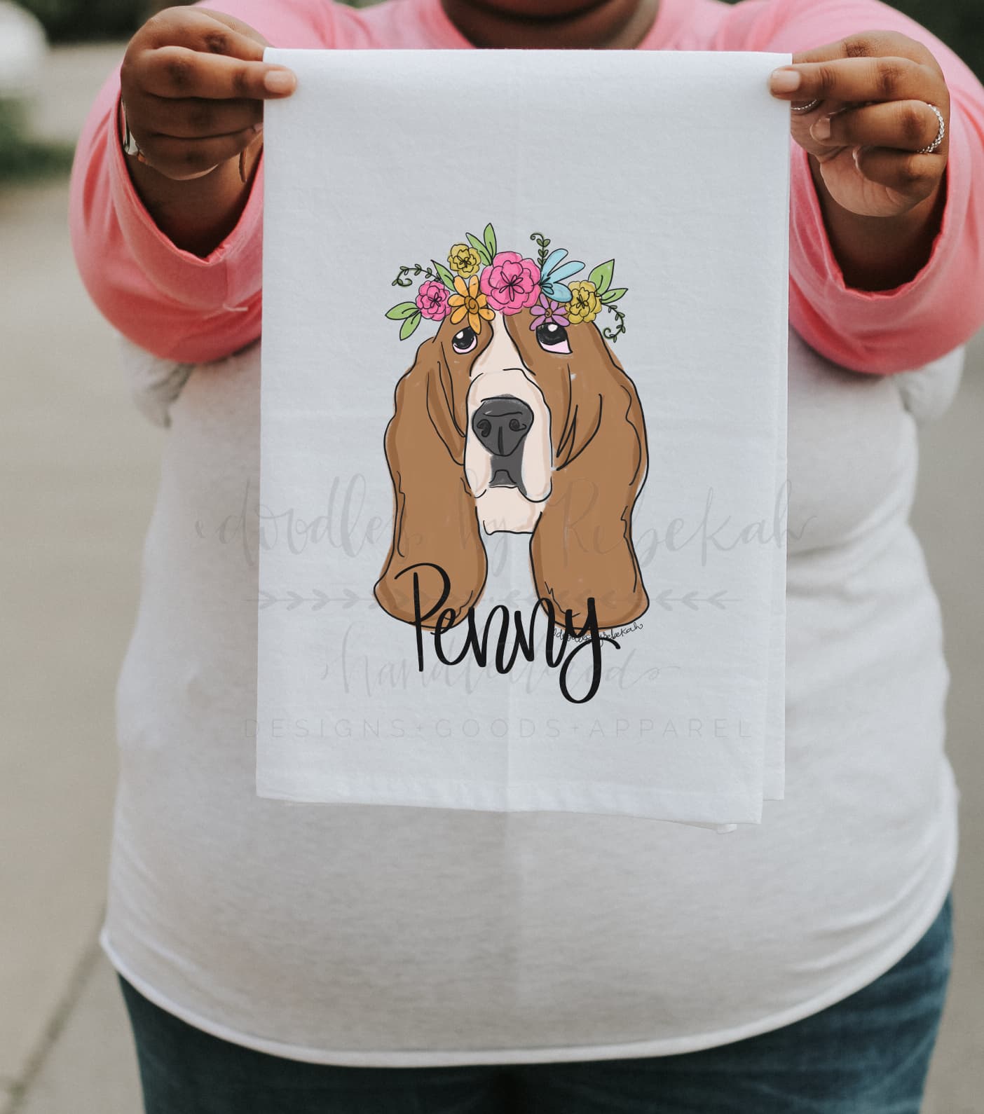 Person holding a personalized tea towel of a basset hound