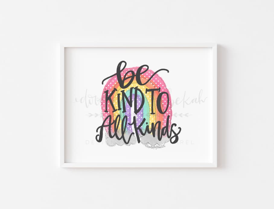An 8x10 print featuring the phrase 'BE KIND TO ALL KINDS' in a colorful, handwritten-style font, centered around a rainbow motif, printed on white cardstock.