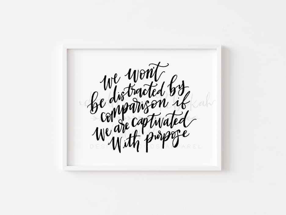 An 8x10 framable print featuring handwritten-style black text on a white background, with the text 'We will be distracted by comparison. But we are captivated by purpose.