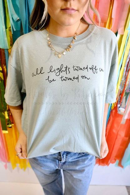 A woman wearing a light grey hand letter tshirt