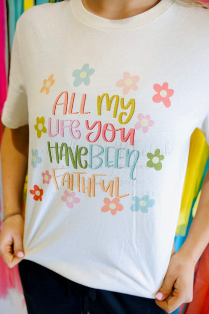 close up of a woman wearing a white tee that reads "All my life you have been faithful"
