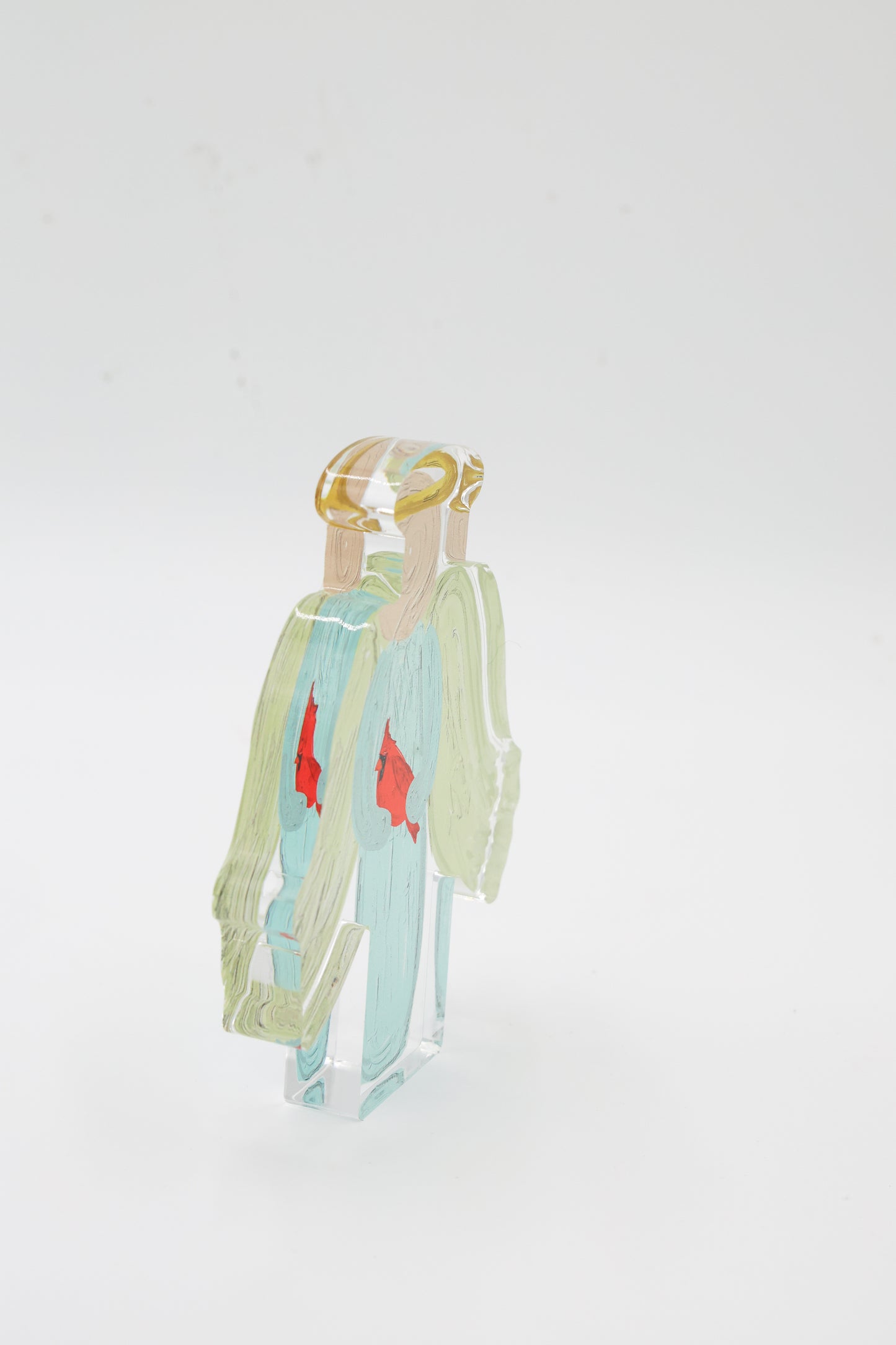 An angel shelf sitter with a cardinal side view with a white background