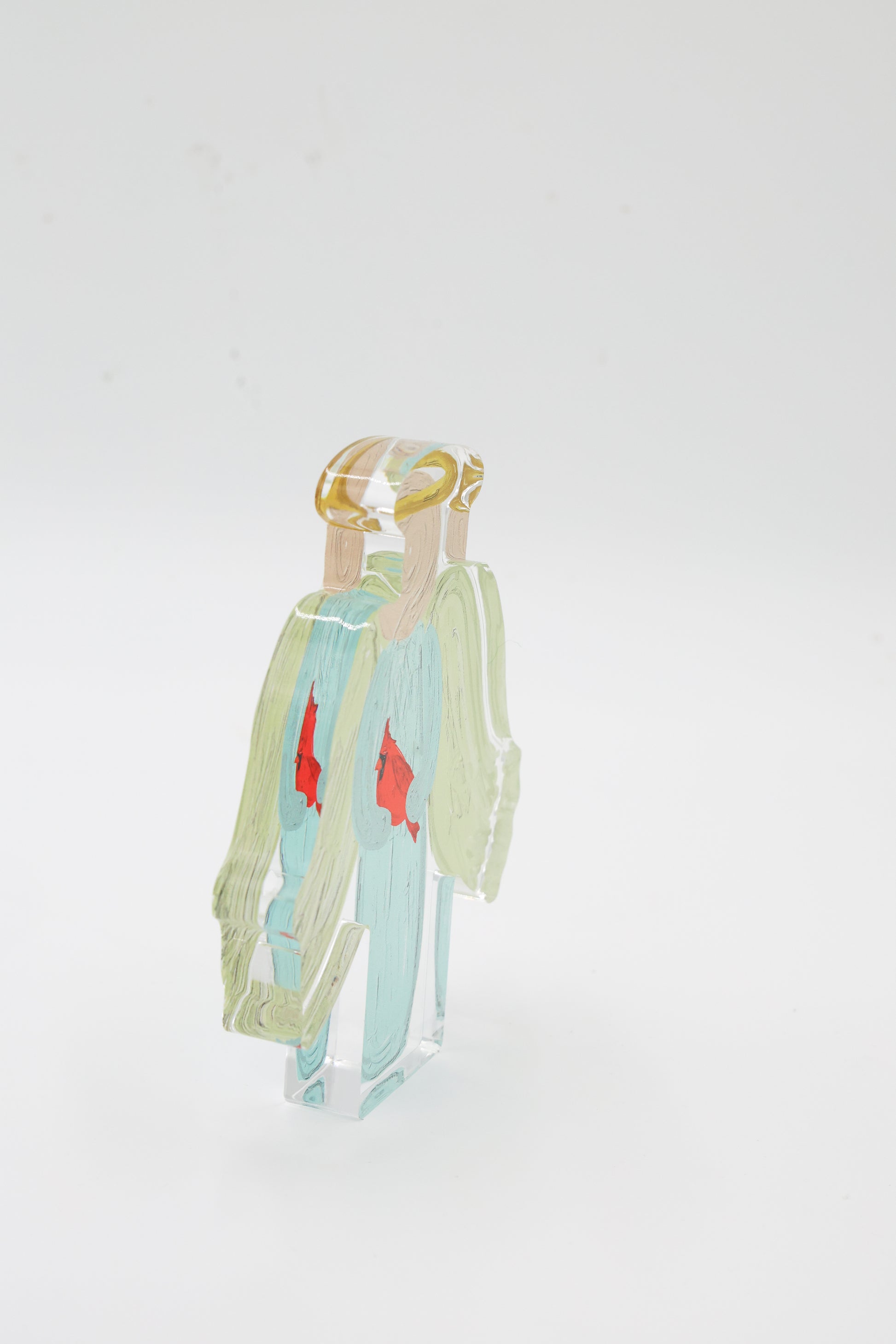 An angel shelf sitter with a cardinal side view with a white background