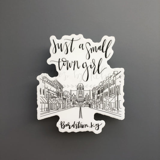 Sticker with a doodle of Bardstown Ky and reference to just a small town girl with buildings 