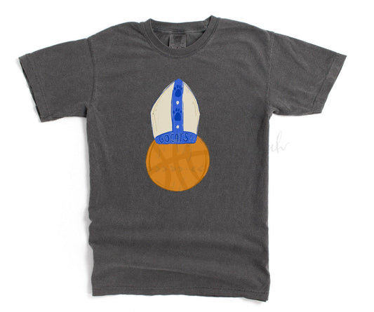 A gray t-shirt with a hand-drawn lettering design featuring a basketball and a stylized pope figure.