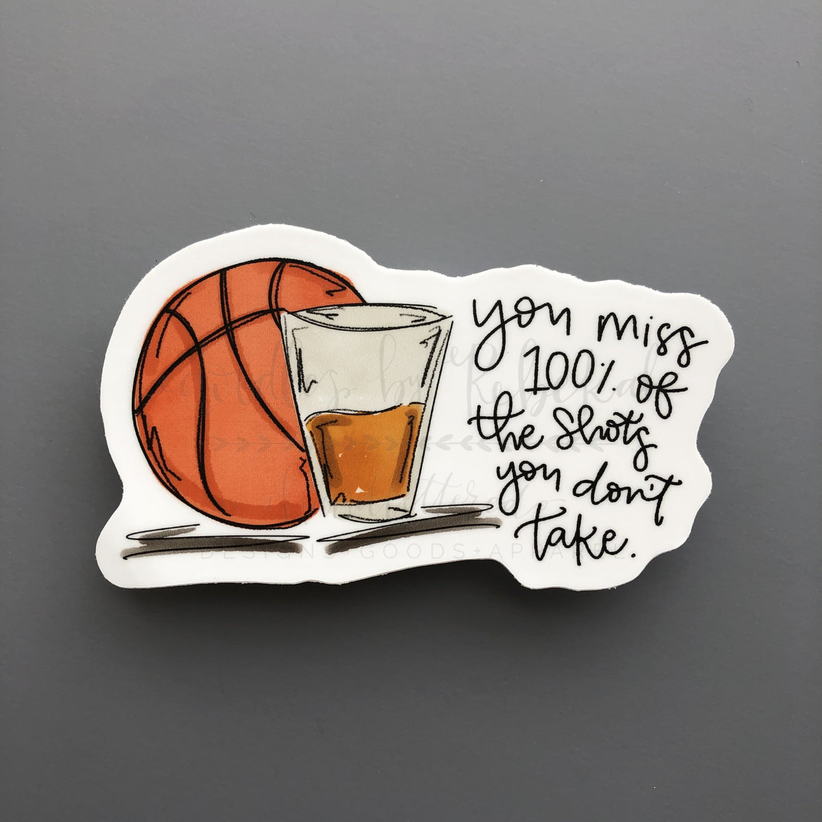 Vinyl sticker of basketball with a shot glass and the phrase "you miss 100% of the shots you don't take"