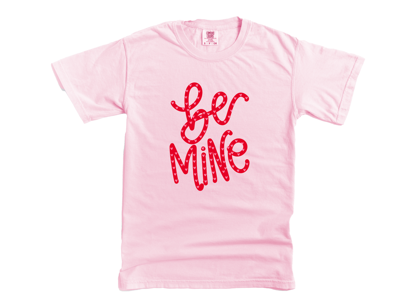 Pink t-shirt with 'Be Mine' text in red on a white background