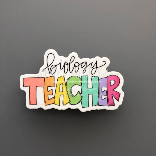 A sticker with the text 'Biology Teacher' in a colorful font, designed for use on laptops or other surfaces.