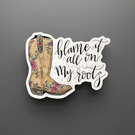 "Blame it all on my roots" sticker with a stylized cowgirl boot