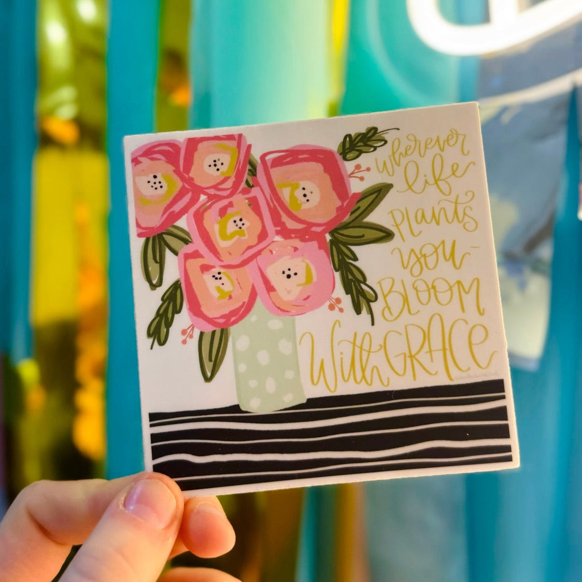 Doodles by Rebekah "Bloom With Grace" inspirational floral square sticker. This colorful hand-painted vinyl decal featuring a pink bouquet and motivational quote is a perfect gift for decorating water bottles, laptops, and journals.