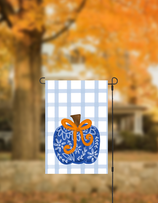 Blue Chinoiserie style pumpkin yard flag with a fall background
