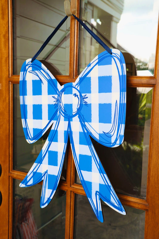 Blue and white checkered bow decoration on a glass door