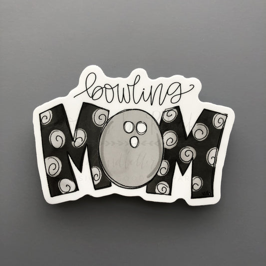 A white sticker with handwritten whimsical text that reads "Bowling Mom"