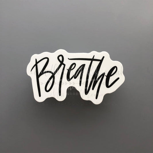A white sticker with the word 'BREATHE' written in black script.