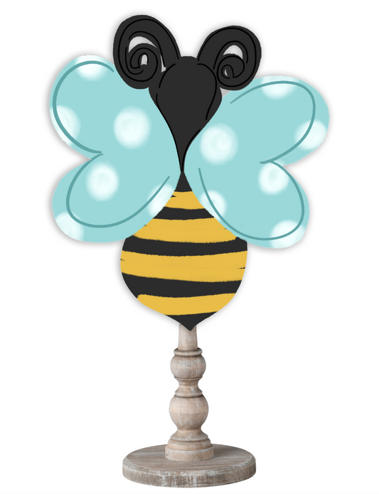 Doodles by Rebekah spring bumblebee art piece featuring a hand-sketched bee illustration with decorative wings on a rustic wood stand.