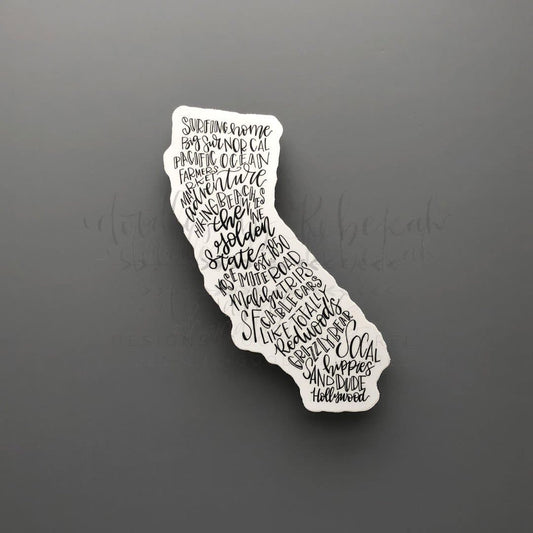 A white sticker in the shape of California with word art for the state