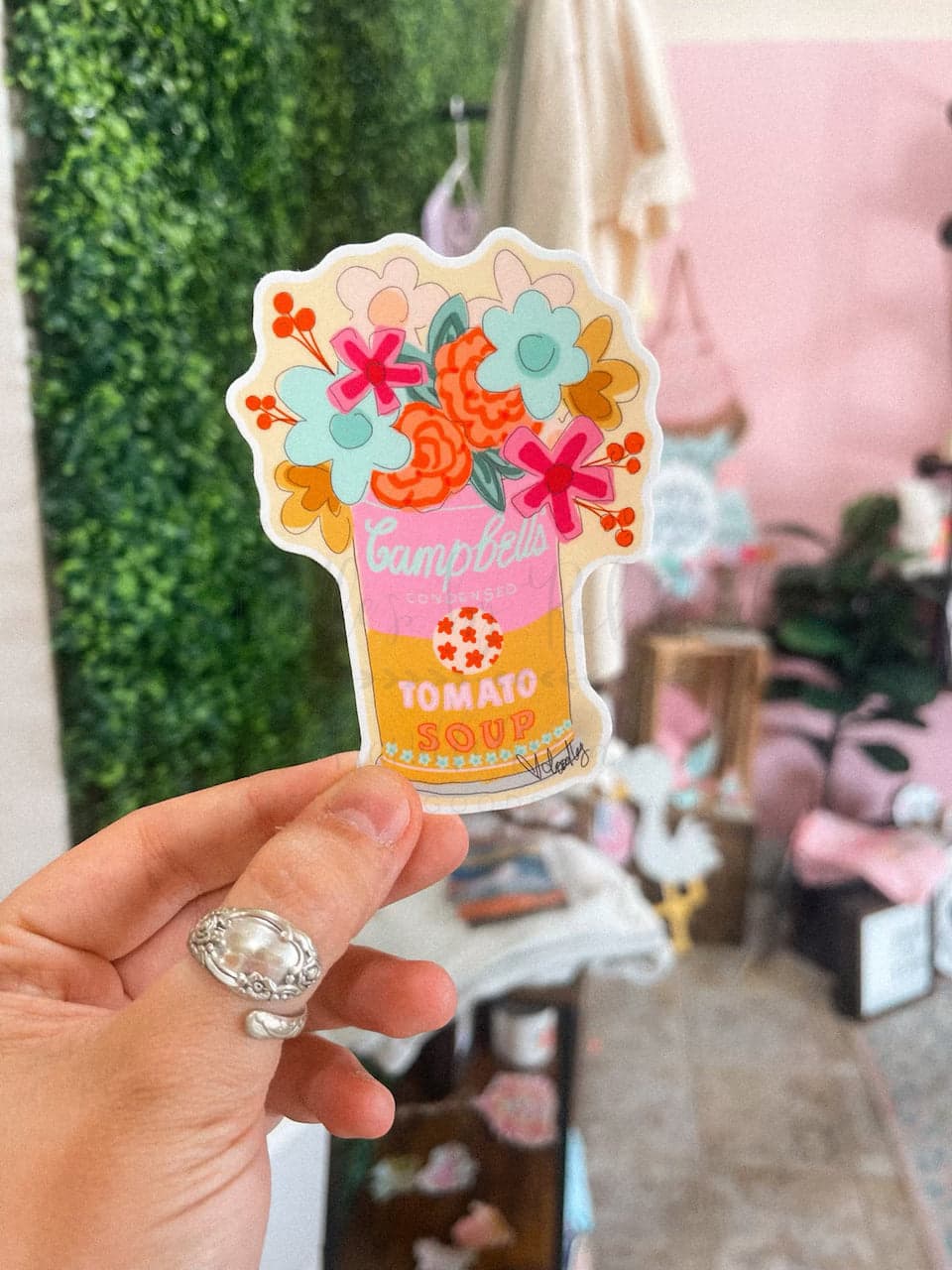 A sticker with a colorful floral design and the text 'CAMPBELL'S SOUP CAN BOUQUET'.