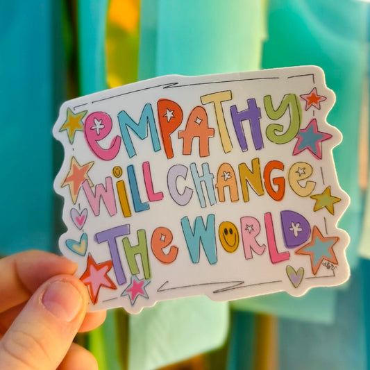Doodles by Rebekah "Empathy Will Change the World" inspirational vinyl sticker. This colorful, hand-painted quote decal features whimsical lettering and star accents, making it a thoughtful gift for teachers, counselors, and advocates to decorate laptops, water bottles, and journals.