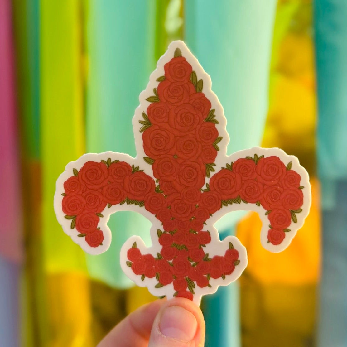 Doodles by Rebekah fleur-de-lis rose vinyl sticker. This whimsical hand-painted floral decal features a classic French symbol filled with red roses, making it a perfect gift for fans of New Orleans, Louisville, or floral art to decorate water bottles, laptops, and planners.