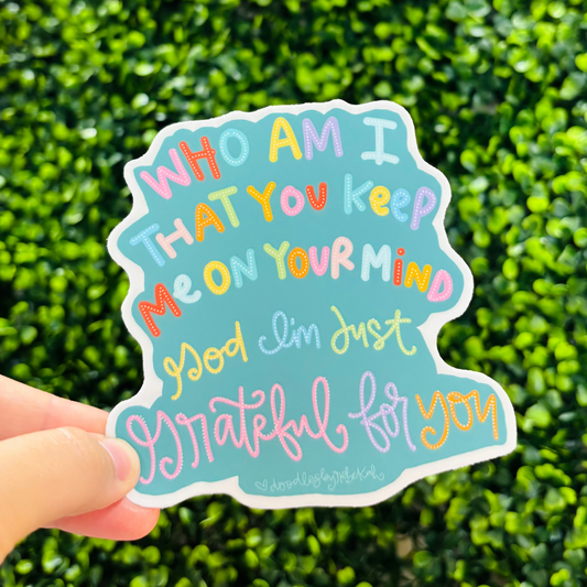 a hand holding a sticker that reads "Who am I that you keep me on your mind God I'm just grateful for you"