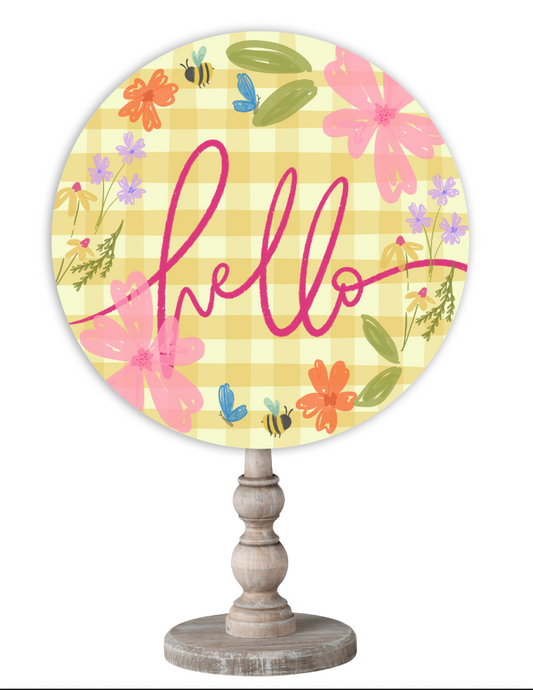 Doodles by Rebekah spring home decor featuring a whimsical floral and bee illustration on a yellow check background with a wooden stand.
