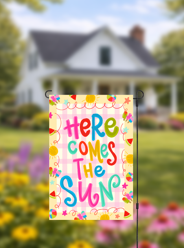 Doodles by Rebekah "Here Comes the Sun" summer garden flag featuring hand-painted typography and a pink checkered pattern. This vibrant outdoor seasonal decor is perfect for brightening up front yards, gardens, or summer pool parties.