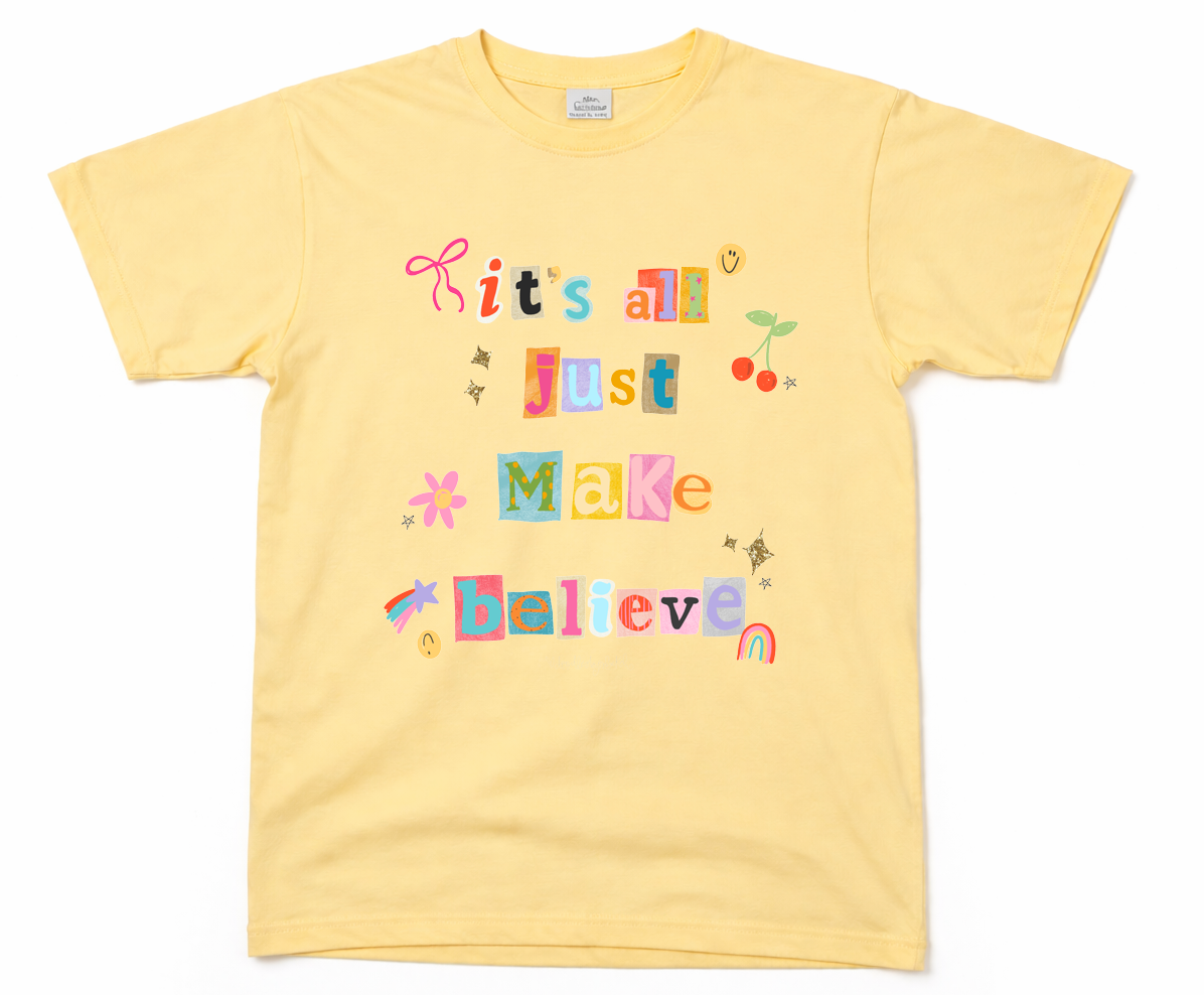 Yellow t-shirt with colorful text that reads "It's All Just Make Believin'" and graphics on a white background
