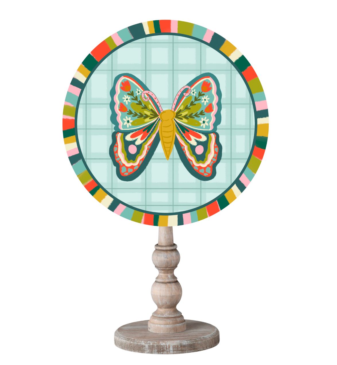A circle topper with a colorful butterfly with floral details in it's wings with a colorful border on top of a wooden dowel 