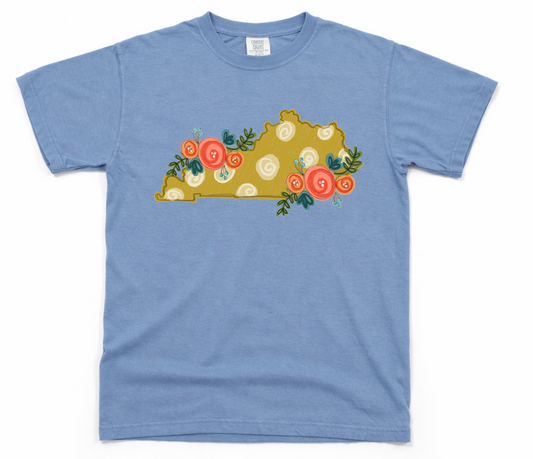 Blue t-shirt with a decorative design of a state map with flowers on a white background
