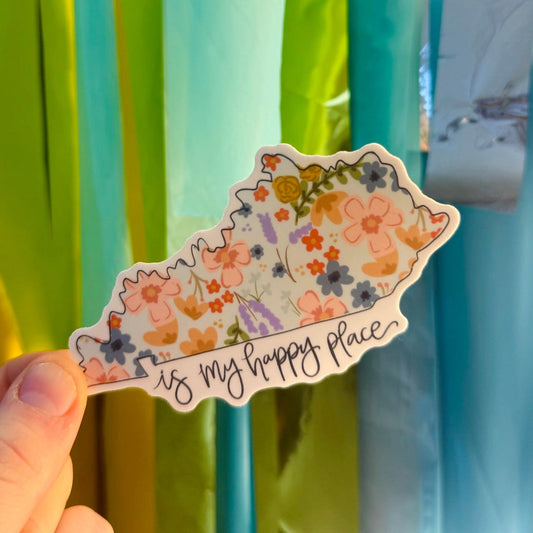 Doodles by Rebekah "Kentucky is my happy place" floral state sticker. This whimsical hand-painted vinyl decal features a botanical Kentucky map design, making it a perfect gift for Kentucky residents, homeowners, or as a cheerful travel souvenir for water bottles and laptops.