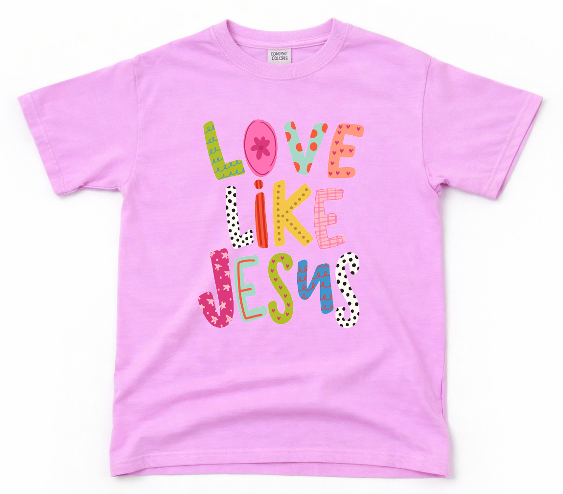 Pink t-shirt with 'Love Like Jesus' text on a white background