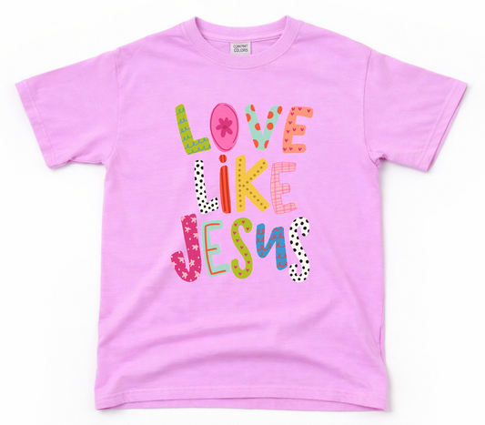Pink t-shirt with 'Love Like Jesus' text on a white background