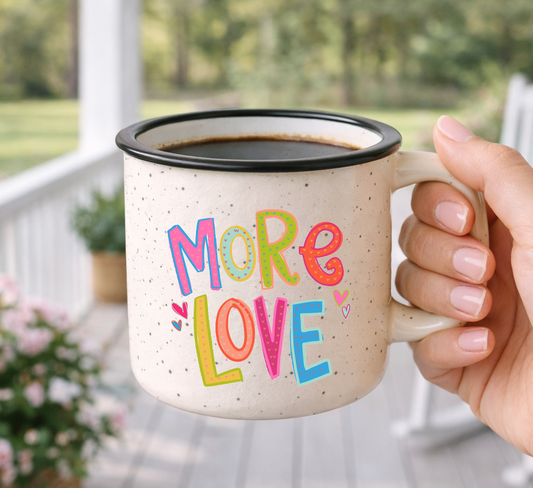 Doodles by Rebekah "More Love" colorful typography mug. This whimsical hand-painted ceramic coffee cup features vibrant lettering and heart details, making it a perfect gift for Valentine's Day, anniversaries, or spreading positivity.