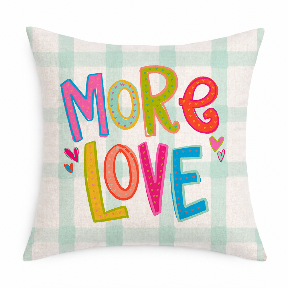Decorative gingham pillow with the phrase "More Love" in colorful letters on a white background 