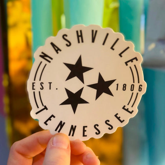 Doodles by Rebekah Nashville, Tennessee black and white minimalist circle sticker. This hand-painted Tennessee state pride decal featuring the iconic three-star design is a perfect travel souvenir for decorating water bottles, laptops, and journals.