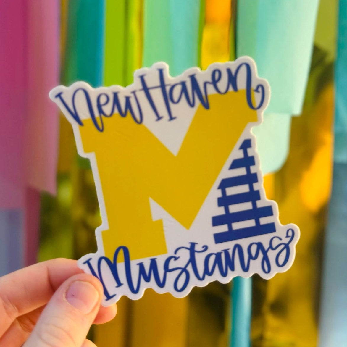 Doodles by Rebekah New Haven Mustangs school spirit sticker. This custom die-cut vinyl decal in yellow and blue is perfect for students, teachers, and alumni to show their school pride on laptops, water bottles, and notebooks.