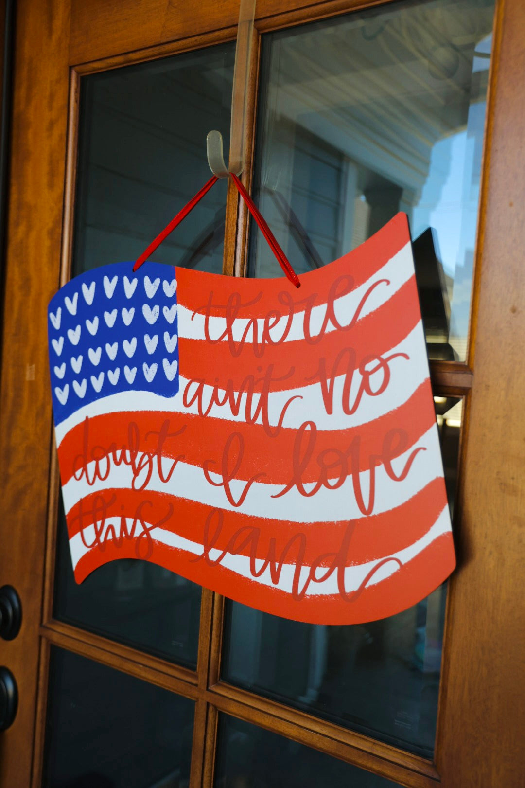 American Flag doorhanger on a wood & glass door