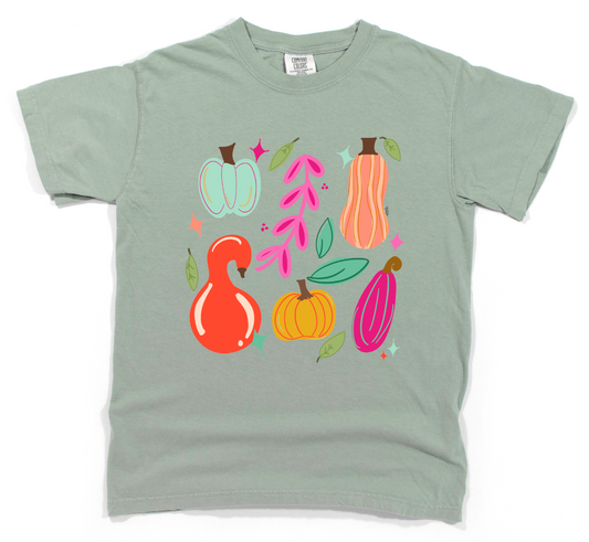 Light green t-shirt with colorful pumpkins and leaves design on a white background