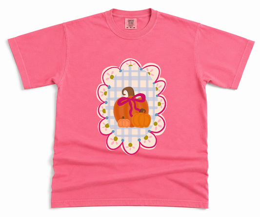 Pink t-shirt with a decorative pumpkin design on a white background