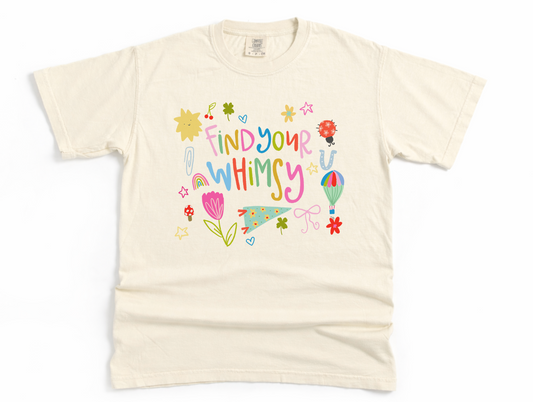 Beige t-shirt with colorful text and graphics on a white background